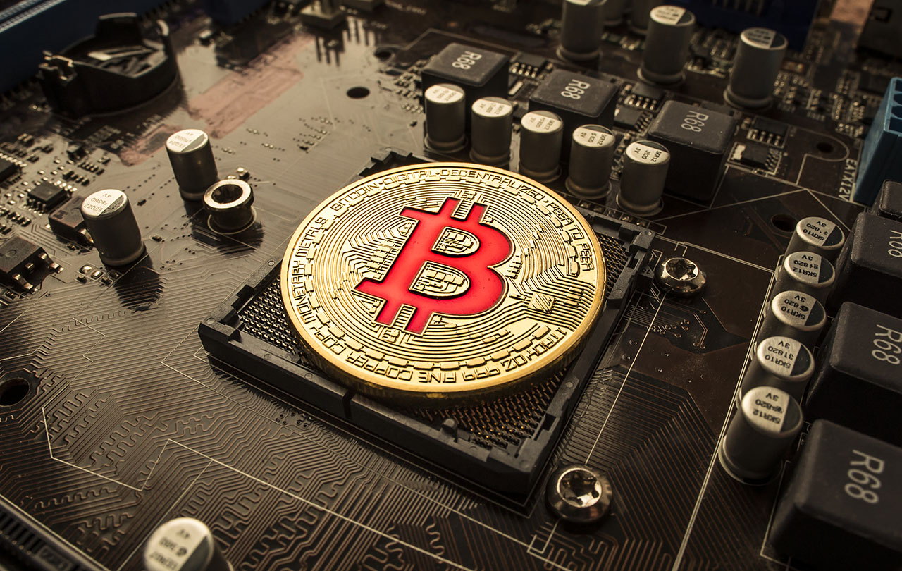 Motherboard Featuring a Bitcoin Token (In Golden Coinage)
