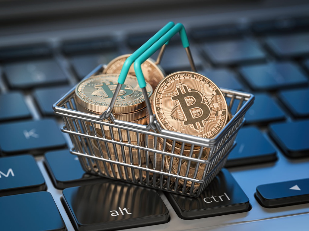 Golden Bitcoins In a Tiny Shopping Basket On Top of a Keyboard
